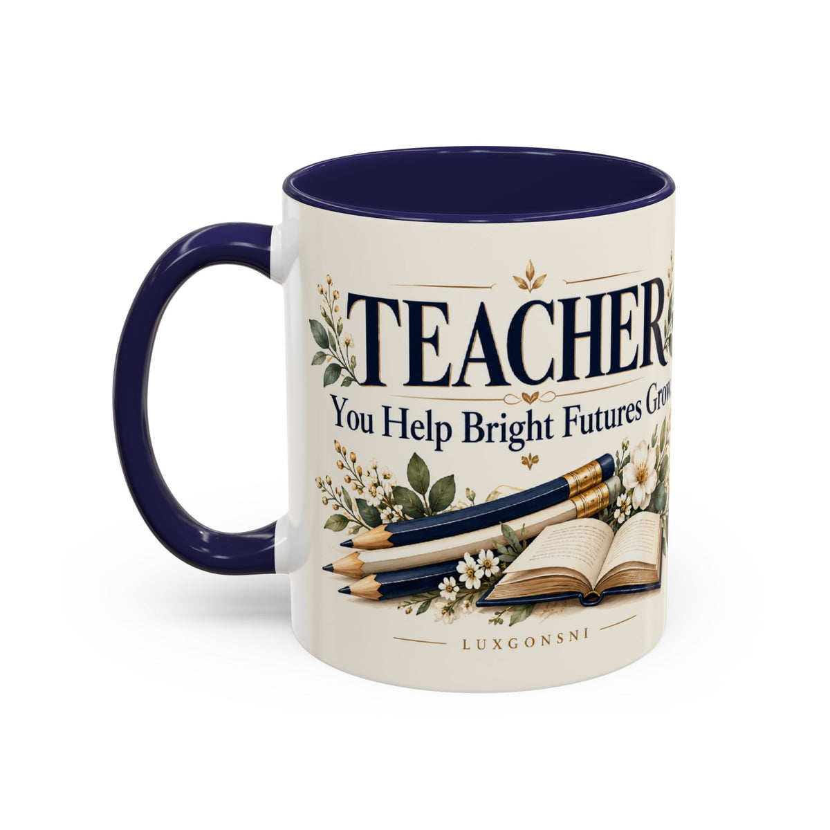 A ceramic mug with a cream-colored exterior and a dark navy blue interior and handle. The mug features a printed design with the word 'TEACHER' in large navy letters, accompanied by illustrations of pencils, an open book, and small white flowers.